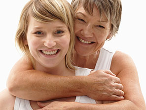 Adult hugging child from behind